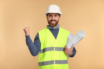 Architect in hard hat with drafts on beige background