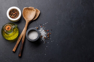 Spices, olive oil, and utensils on cooking table