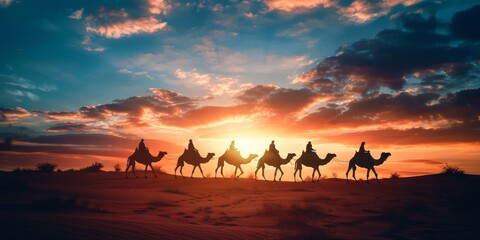 A group of camels are walking across a desert at sunset