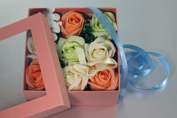 open gift box with handmade soap and blue ribbon