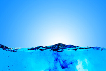 Blue ink scattered in the abstract background of water.