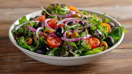 Fresh salad with olives, cherry tomatoes, lettuce and red onion
