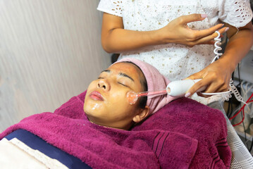 Obraz na płótnie Canvas facial treatment with laser and ultrasound in a medical spa center skin rejuvenation concept