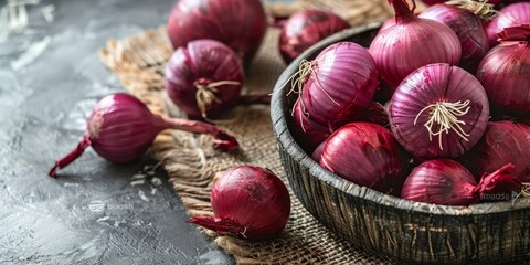 A bunch of red onions are piled on top of each other