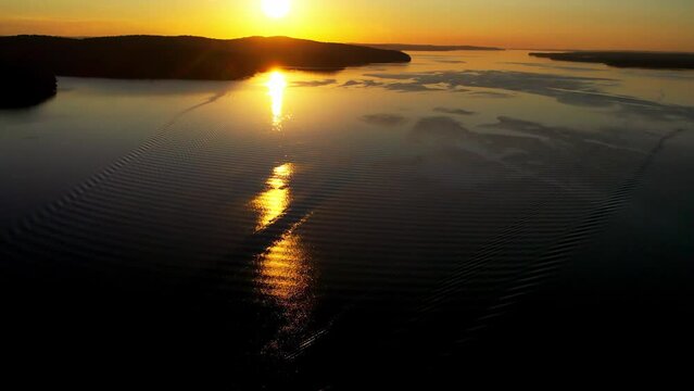 "Capture the breathtaking beauty of Lake Baikal and the Angara River from above in stunning aerial footage. Ships and boats glide through the crystal-clear waters, offering fantastic views.
