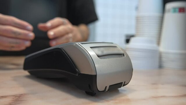 Woman buy take away coffee use nfc cashless payment close up. Contactless money transaction. Hipster girl pay food order credit card closeup. Bank terminal bill Barista man sell hot tea drink cup cafe