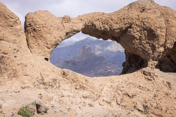 The rock formation Ventana del Bentayga (Window to Bentayga) with the peak Roque Bentayga behind. The formation looks like a kissing camel and elephant.