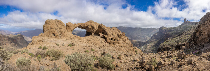 Panoramic image of the rock formation Ventana del Bentayga (Window to Bentayga). The formation looks like a kissing camel and elephant. To the far right the famous peak Roque Nublo.