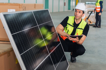 man in a yellow vest is looking at a solar panel