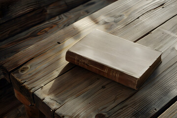 A closed bible book on a wooden table - obrazy, fototapety, plakaty