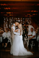 Valmiera, Latvia - August 13, 2023 - A bride and groom embrace and share a kiss on the dance floor,...