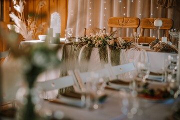 Valmiera, Latvia - Augist 13, 2023 - Elegant wedding table setting with floral centerpiece,...