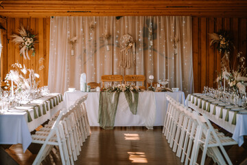 Valmiera, Latvia - Augist 13, 2023 - Rustic wedding venue with tables, chairs, and fairy lights...