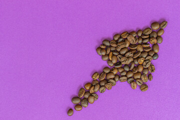 coffee beans laid out in the form of an arrow on a purple background, coffee arrow as a symbol of the rising price of coffee beans, rising price of coffee, growing coffee consumption concept