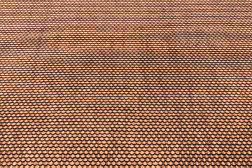 Light brown old weathered circular wooden shingles roof background or texture