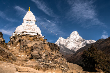 Tibetan Buddshims stupa with Ama Dablam peak near Namche Bazaar in the Himalaya in Nepal