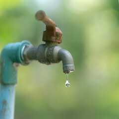 old water tap faucet with water dripping drops