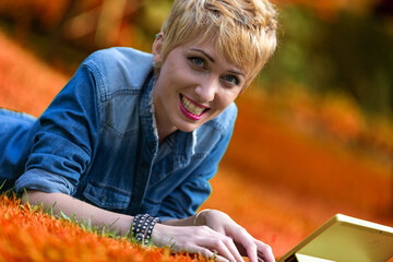 Tablet captures her smile, autumn colors backdrop