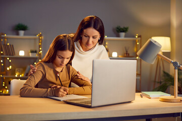 Mother and young daughter witting task, letter near laptop, family in love, happy motherhood...