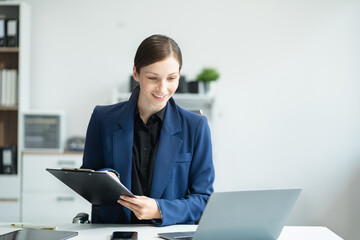 Business woman or financial data analysts working with smartphone and laptop computers and data...