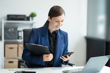 Business woman or financial data analysts working with smartphone and laptop computers and data...