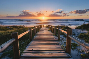 A wooden walkway at a beach during the sunrise