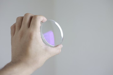 close up of hand holding a magnifying glass