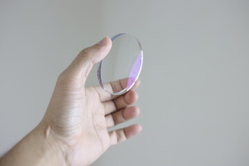 hand with glasses lens 
