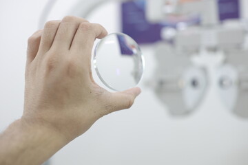 close up of a hand holding a lens glasses in optical store 