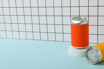 Tin cans on blue table on light background, space for text