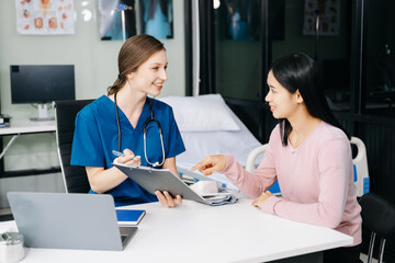 Female doctor using clipboard is delivering great news talk discuss results or symptoms with female patient in clinic or hospital