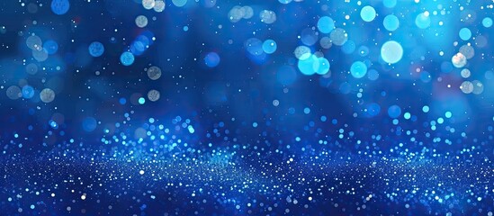 Electric blue liquid sparkles on a blue background like drizzle in a storm. The aqua drops glisten with moisture, creating a mesmerizing fluid effect