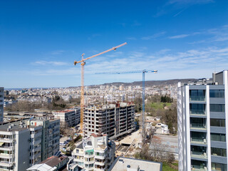 Busy Construction Site With Cranes and Buildings