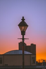 Vertical of a lamp post, street lantern captured against the sunset sky