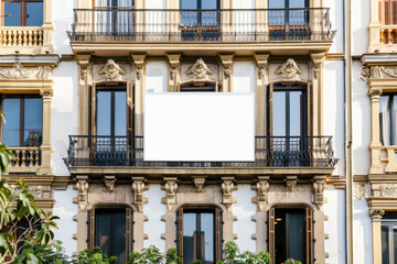 Fototapeta na wymiar Elegant building facade with a blank advertising billboard in urban setting