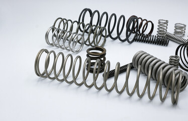 Metal springs of different shapes and sizes. White background. 