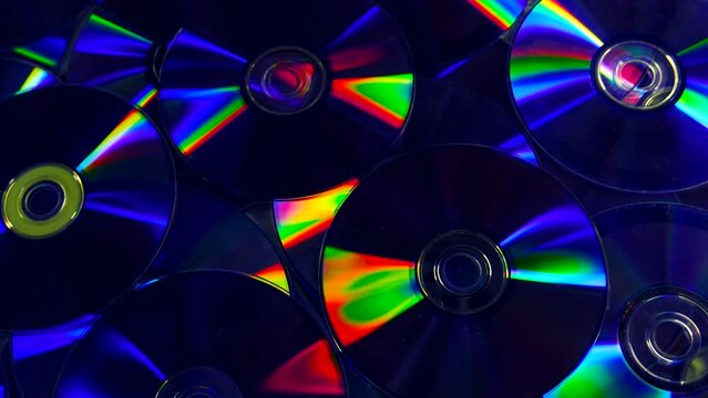 Closeup video of colorful dvd discs with iridescent highlights on the surface