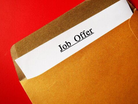 Office envelope with text written on ducuments JOB OFFER -  invitation from employer for potential employee to work in a specific position with high salary and benefits