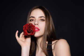 Beauty girl with red rose. Beautiful sensual woman hold flowers, studio portrait.