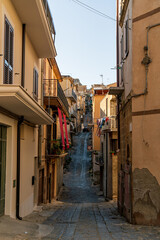 Pietraperzia, Sicily, Italy. Historical city center. Narrow street with houses. Summer sunny day