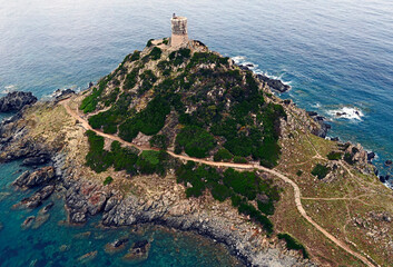 Landscape with hill, old tower and sea coast. Region Iles Sanguinaires, Island Corsica, France	