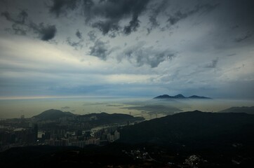 Beautiful view over the city with the sea in the background under the gloomy cloudy sky