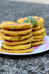 Vertical shot of the homemade Potato pancakes put on the plate on blurred background