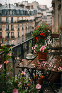 A parisian balcony with a wooden table and a coffee, street view