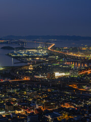 Beautiful top view of urban city with many buildings by the sea at night, Great Seto Bridge in Sakaide City in Kagawa Prefecture in Japan, Travel or outdoor, High resolution over 50MP