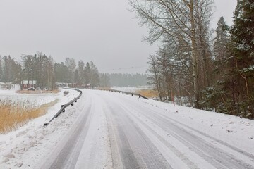 Winter landscape view of plowed road in cloudy winter weather, Pellinki, Finland.