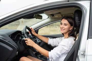 young caucasian woman hold steering wheel and driving car