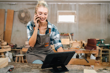 In a bustling carpenter's shop, a young woman craftsman expertly navigates her workshop, merging...