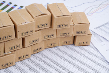 Cargo business concept. Many carton boxes on financial documents.	