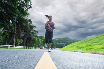 Asian woman jogging and running at park.Healthy and Lifestyle concept.